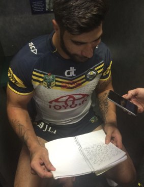 The notebook: James Tamou reads his grand final message.