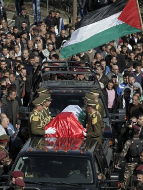 The coffin of Ziad Abu Ein is taken to his final resting place.