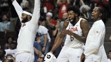 Talent everywhere: DeMarcus Cousins, DeAndre Jordan and Kevin Durant celebrate on the bench after Jimmy Butler dunked against Venezuela.