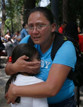 A woman hugs a child outside a school in the Roma Norte neighbourhood of Mexico City, after Tuesday's earthquake .