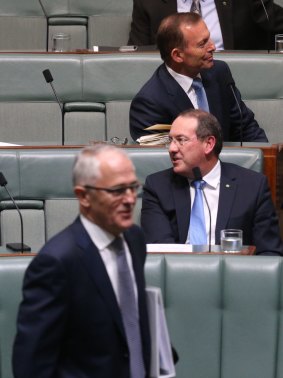 Tony Abbott takes his seat as Prime Minister Malcolm Turnbull arrives for question time.