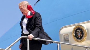 All tied up: President Donald Trump arrives at Orlando International Airport on Friday.