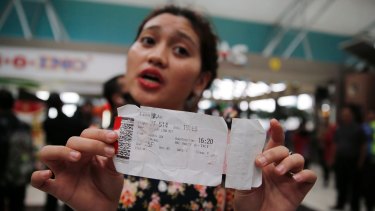 Lina Febriyani, a Lion Air passenger, shows the boarding pass of her delayed flight at Soekarno-Hatta Airport in Jakarta.