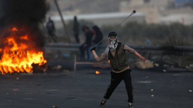 Palestinians clash with Israeli troops following a protest against US President Donald Trump's decision to recognise Jerusalem as the capital of Israel, in the West Bank City of Nablus, on Sunday,