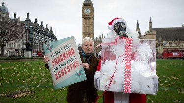 Corre (in mask) with mum Vivienne Westwood protesting in London in 2014.