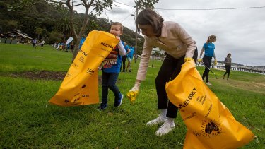NSW Premier Gladys Berejiklian, pictured on Clean Up Australia Day in 2017, has been urged to ban plastic bags.