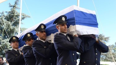 Members of a Knesset guard carry the flag-draped coffin of the former Israeli leader Shimon Peres at Mount Herzl Cemetery in Jerusalem on Friday.
