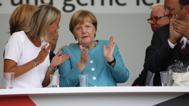 Angela Merkel claps while at a campaign stop on Wednesday.