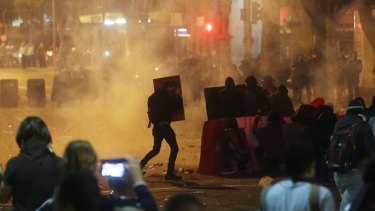 Tear gas is fired during an anti-Temer protest in Rio de Janeiro which followed the release of the audio tape.