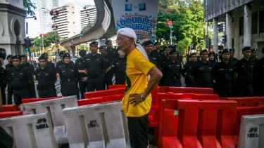 A Bersih supporter stands in front of the Royal Malaysia Police on a blocked road in Kuala Lumpur on Saturday.