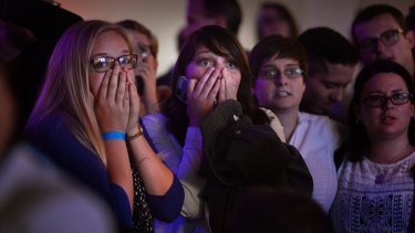 People react to the announcement that Republican presidential candidate Donald Trump has carried another state in Salt Lake City.
