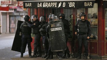 Police officers take up positions in Saint-Denis, a northern suburb of Paris, on Wednesday.