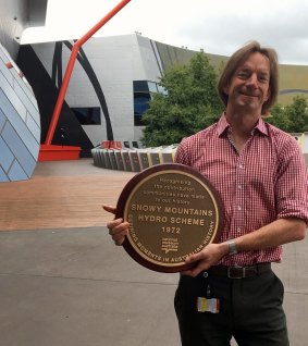 National Museum of Australia curator, Jonathan Lineen, who curated the "Defining Moments'' history project,  with the plaque that will be presented to the town of Cooma on Sunday.