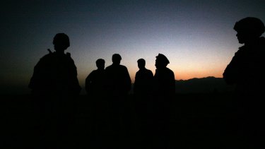 U.S. Army soldiers stand with Afghan policemen before a joint patrol of Qalanderkhail, outside of Bagram Air Field in Afghanistan.