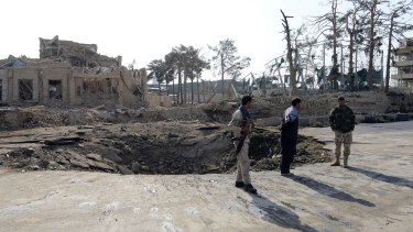 Afghan security personnel guard at the explosion spot near German consulate in Mazar-i-Sharif.