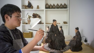 Artisans at work in the studio of Zhang Yu, a sculptor in the sixth generation of disciples of the original artist known as Clay Man Zhang, in Tianjin.