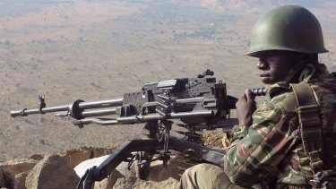 A Cameroonian soldier keeps watch at an observation post on a hill in the Mandara Mountain chain in Mabass, northern Cameroon.