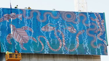 A giant print of Indigenous artist Ray Traplin's painting Life in the Ocean has been hung from a skyscraper being built in Little Lonsdale Street.