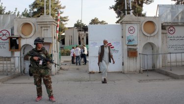 An Afghan National Army soldier stands guard at the gate of the Kunduz MSF hospital earlier this month.  