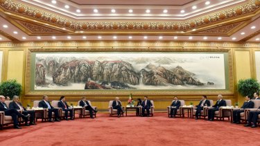Chinese President Xi Jinping, center right, speaks to Swiss Economy Minister Johann Schneider-Ammann at the signing ceremony for the Articles of Agreement of the Asian Infrastructure Investment Bank at the Great Hall of the People in Beijing on Monday.