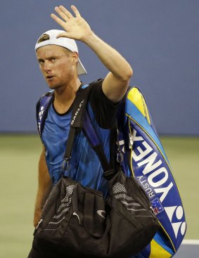 Lleyton Hewitt bids farewell to the crowd after losing to Bernard Tomic.