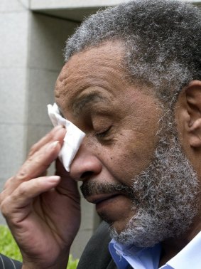 Anthony Ray Hinton wipes away tears after greeting friends and relatives.