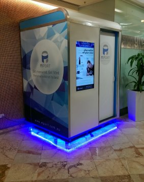 The mPort kiosk looks a little like a shopping centre photo booth.