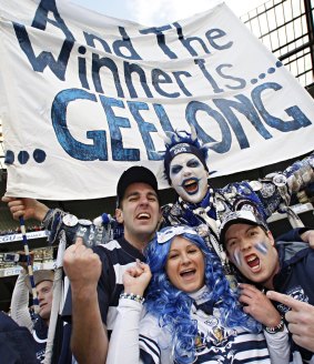Geelong fan Troy West, aka Catman, celebrates with other cheer squad members. 