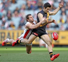 Tigers skipper Trent Cotchin is tackled by Maverick Weller.