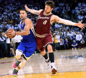 Shadowing: Matthew Dellavedova plays close defence on Steph Curry on Christmas Day.