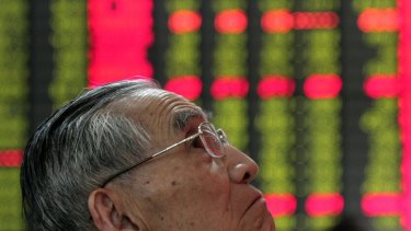 One of a growing number of Chinese investors watches stock prices on the Shanghai Composite Index.
