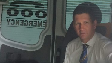 LNP leader Lawrence Springborg visits a Brisbane ambulance station, projecting business as usual while the state election outcome is decided.