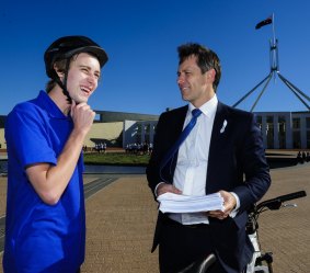 Stroke victim Luke Webb delivers his petition asking for more action on strokes to Labor MP Jason Clare. 