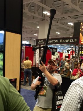 A visitor to the April 2015 Nashville meeting and exhibition poses with one of the firearms on sale there.
