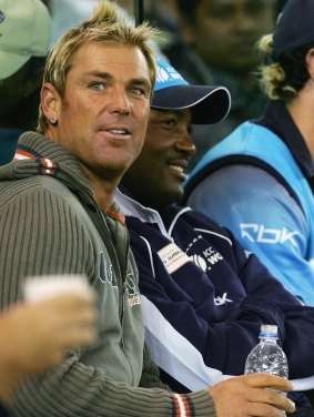 Long-time mates: Shane Warne sits on the sidelines with Brian Lara during the World XI game in Melbourne in 2005.