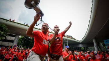 Pro-government 'red-shirt' protesters shout slogans during a demonstration in Kuala Lumpur on Wednesday.