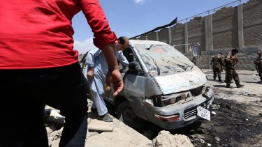 Inspecting damage after the car bomb attack in Kabul on Sunday.
