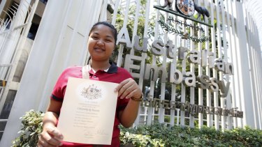 Pattharamon Janbua with a certificate of Australian citizenship for Gammy outside the Australian embassy in Bangkok earlier this month.