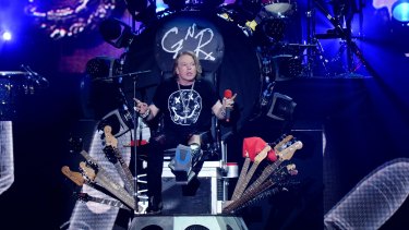 Nursing a broken foot, Axl Rose of Guns N' Roses performs on a throne at Coachella on Saturday. His promotion to the job of lead singer for AC/DC has angered fans.
