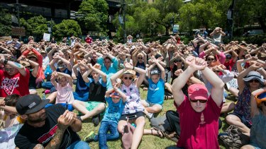Protesters at First Fleet Park in Sydney clasp arms in the air to demonstrate solidarity with the men on Manus inj November.