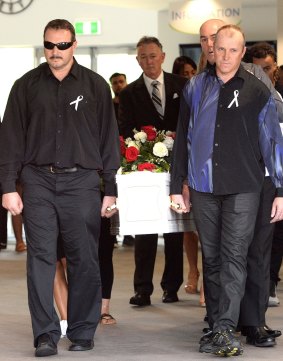 Tara Brown's coffin is carried by family and friends at her funeral.