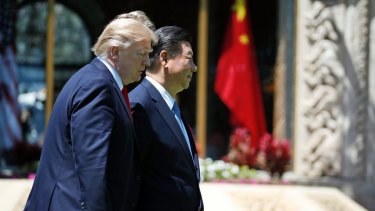 Donald Trump and Xi Jinping walk together after their meetings at Mar-a-Lago.