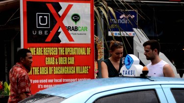 Uber defies Bali ban, offers free car rides and chopper trips