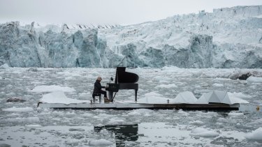 Italian composer and pianist Ludovico Einaudi performs one of his own compositions on a floating platform in the Arctic Ocean, in front of the Wahlenbergbreen glacier, in Svalbard, Norway, to highlight the impact of climate change.