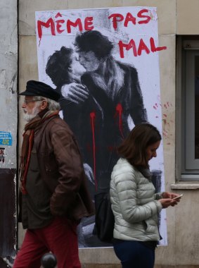 Posters of lovers with bullet wounds and the statement "not even hurt" have appeared in Paris.