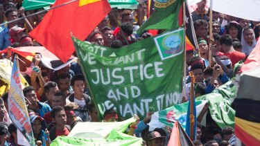 At least 10,000 people gathered outside the Australian embassy in Dili, the capital of East Timor, on Tuesday to protest against Australia's stance on the oil and gas meridian line in the Timor Sea.  