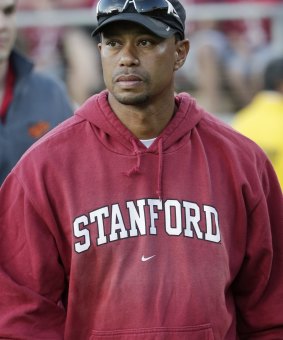 Tiger Woods walks the sideline during an NCAA college football game earlier this month.