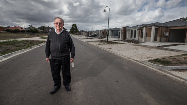 Jack Mercovich in front of a row of new housing in his suburb of South Morang. 