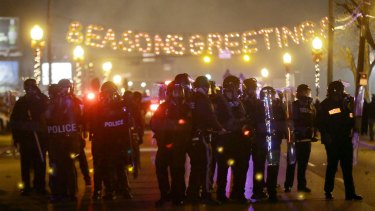 Police gather on the streets of Ferguson after the announcement of the grand jury's decision.
