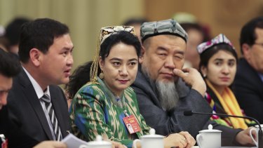 Delegates from Xinjiang attend the Xinjiang group meeting at the Great Hall Of The People in Beijing on March 12.